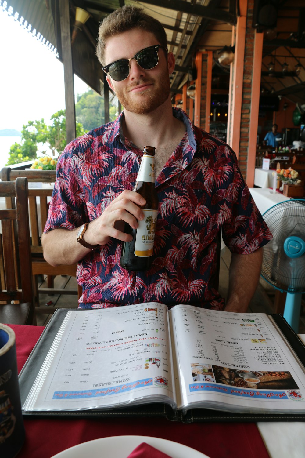 man holding beer bottle