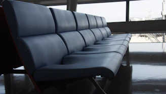 A row of comfortable aluminium waiting area chairs with cushioned seats.