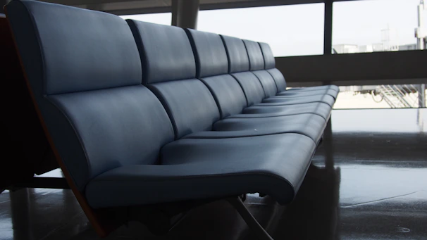 A row of comfortable aluminium waiting area chairs with cushioned seats.