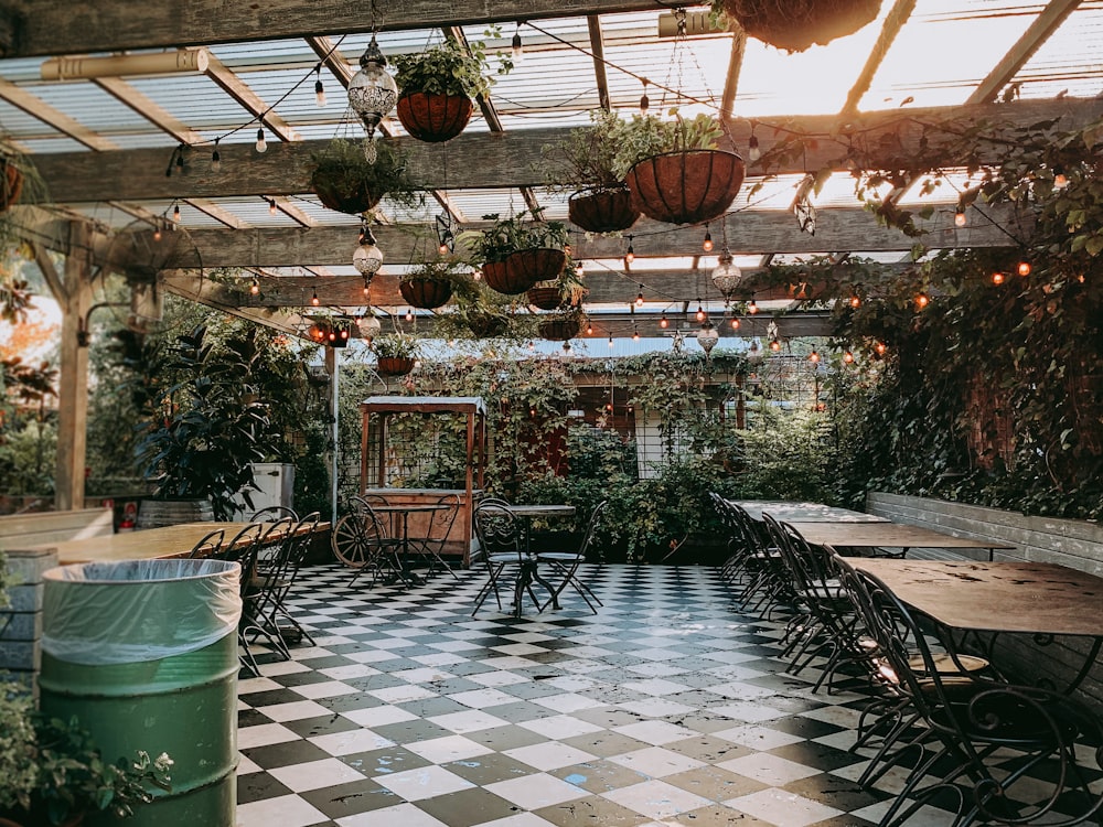 food cart near empty dining sets inside pergola during day