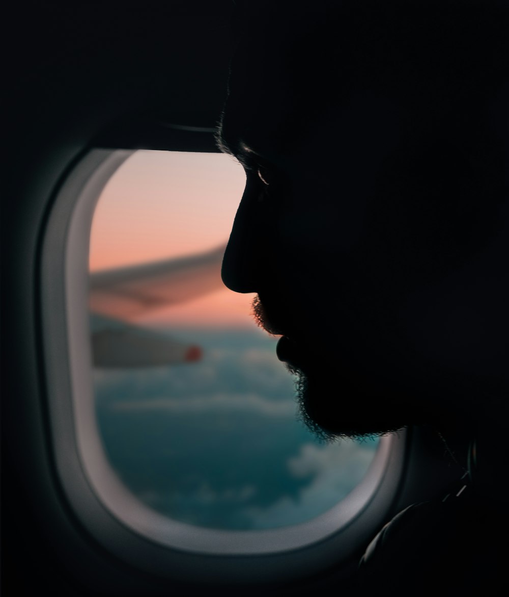 silhouette of man beside of airplane mirror