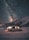 A camper van is parked on a snowy landscape with a backdrop of a dark, star-filled sky. The Milky Way is visible, creating a breathtaking scene. The van's interior is softly lit, adding warmth against the cold, vast night sky and rugged mountains.