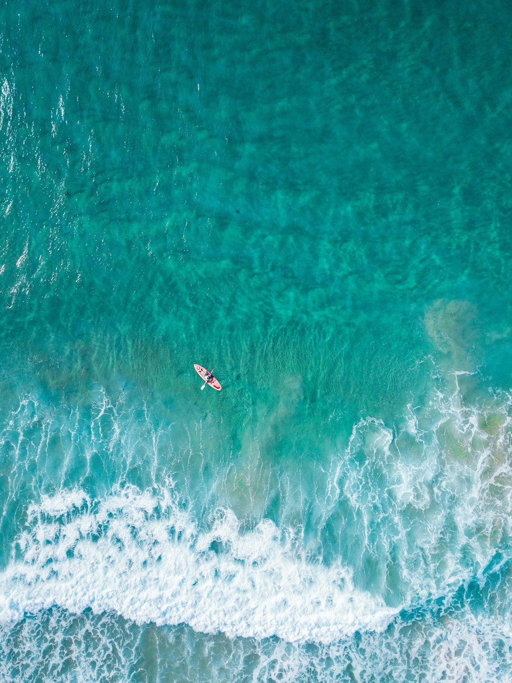 aerial view of person at the boat on the ocean