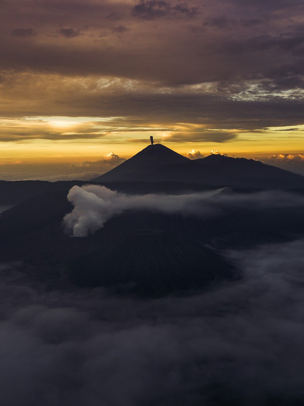 a view of a mountain with a cross on top of it