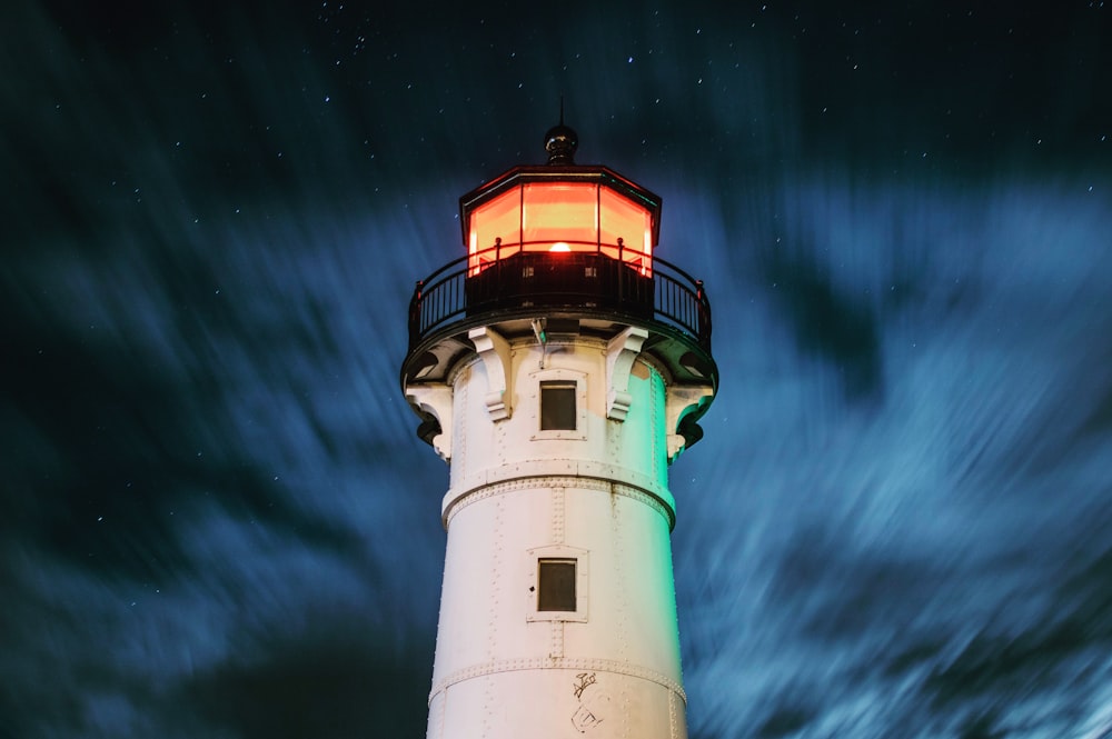 selective focus photography of white and black lighthouse