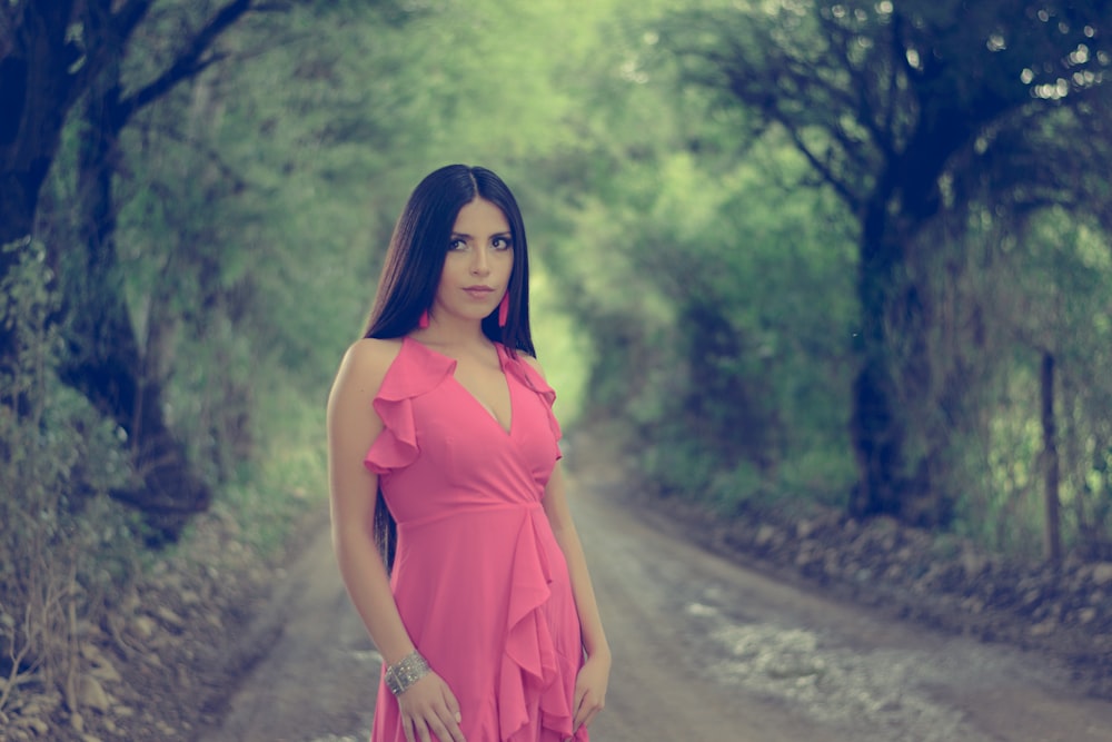 woman in pink deep V-neck sleevlessleeveless dress