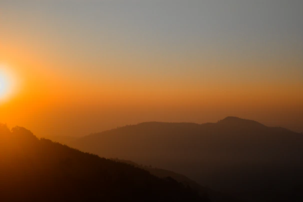 A vibrant sunrise over the rolling hills and traditional villages of Sumba.
