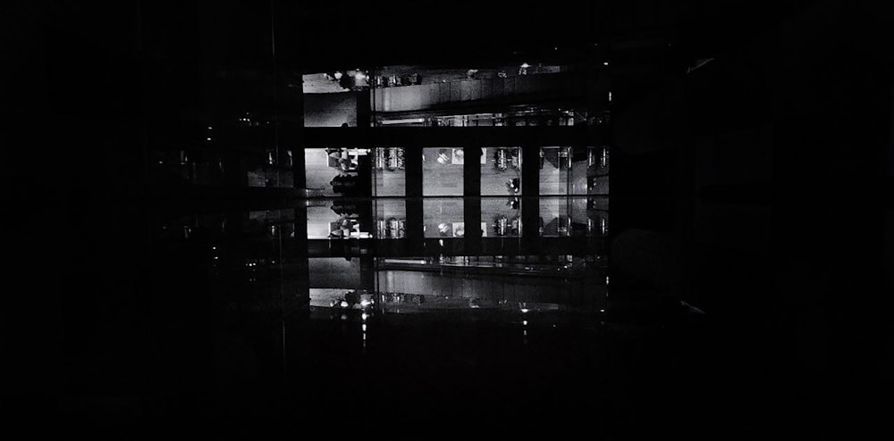 a black and white photo of a building at night