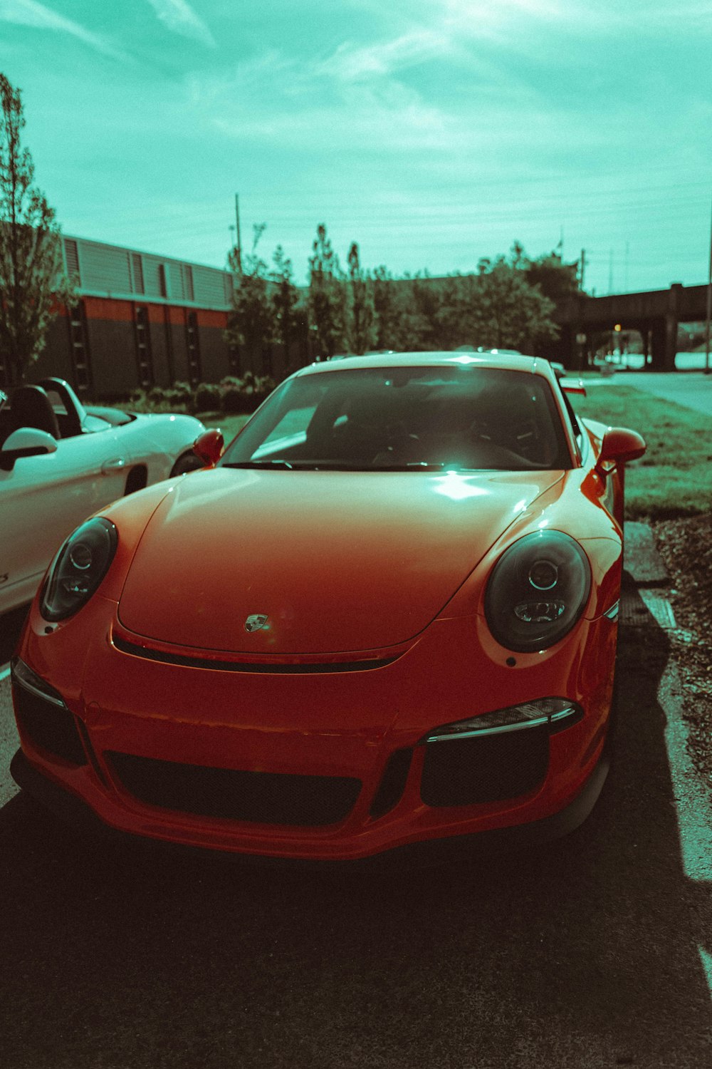 red car parked beside buildings