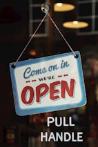 come on in we're open signage on glass panel