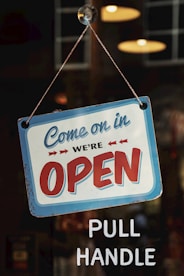 come on in we're open signage on glass panel