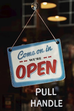 come on in we're open signage on glass panel