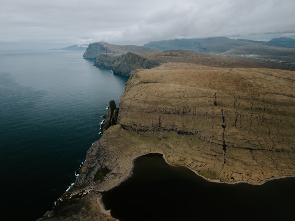high angle photography of cliffs near body of water