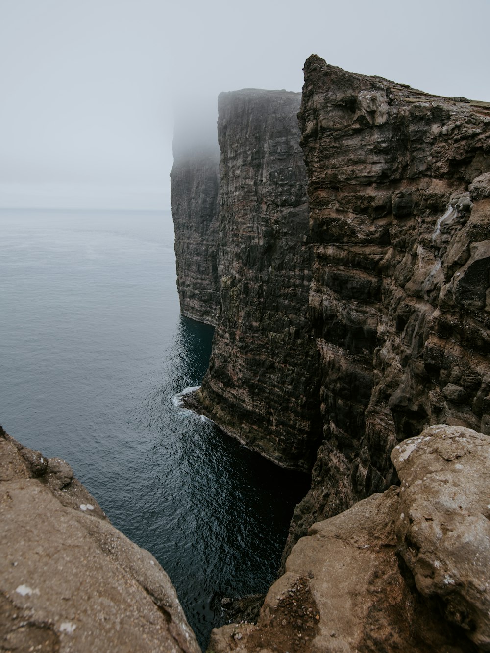 cliff beside body of water