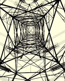 A symmetrical view of a transmission tower from directly beneath, showcasing intricate crisscrossing metal beams and cables. The structure creates complex geometric patterns against a light background.