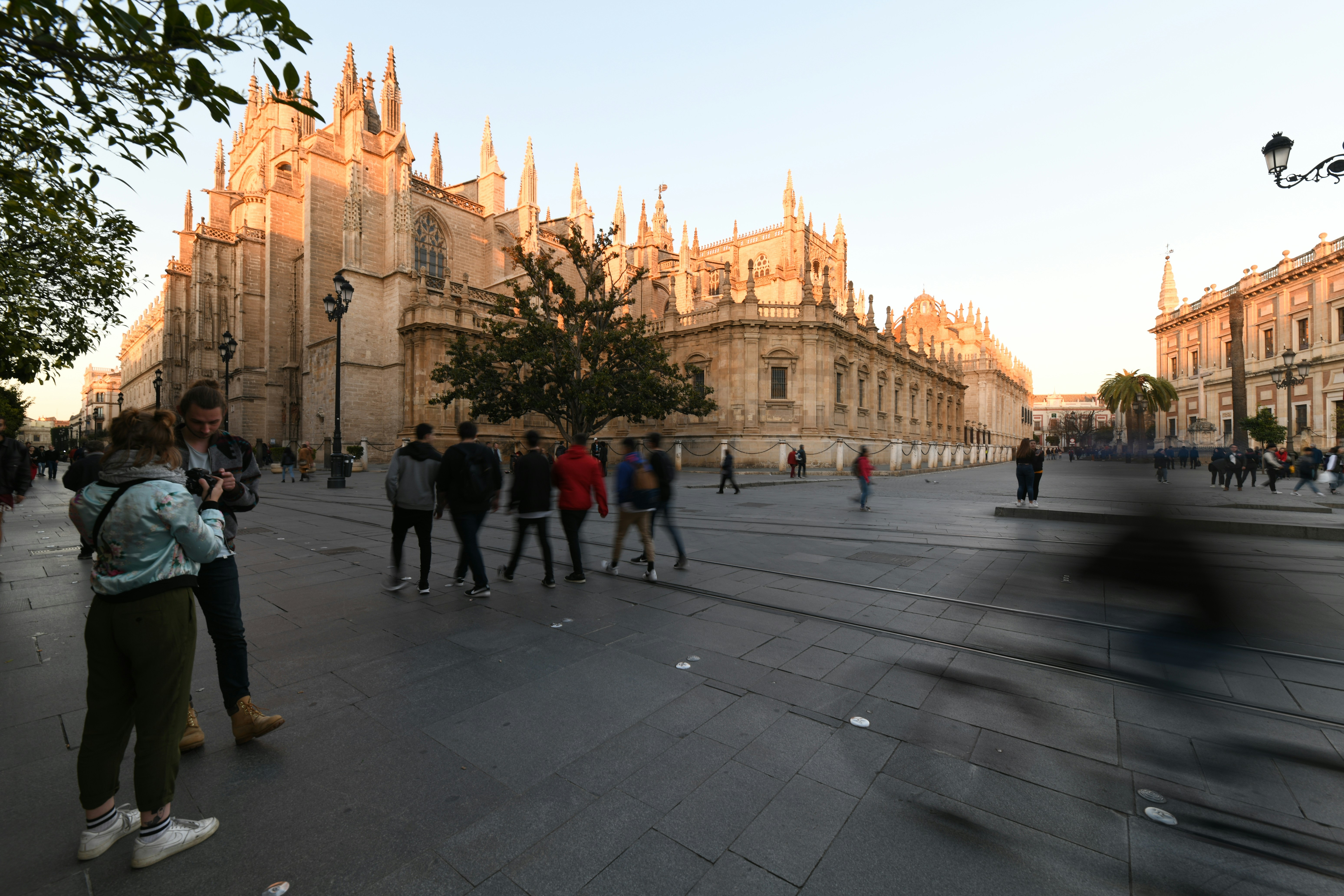 people walking near brown concrete church during daytime