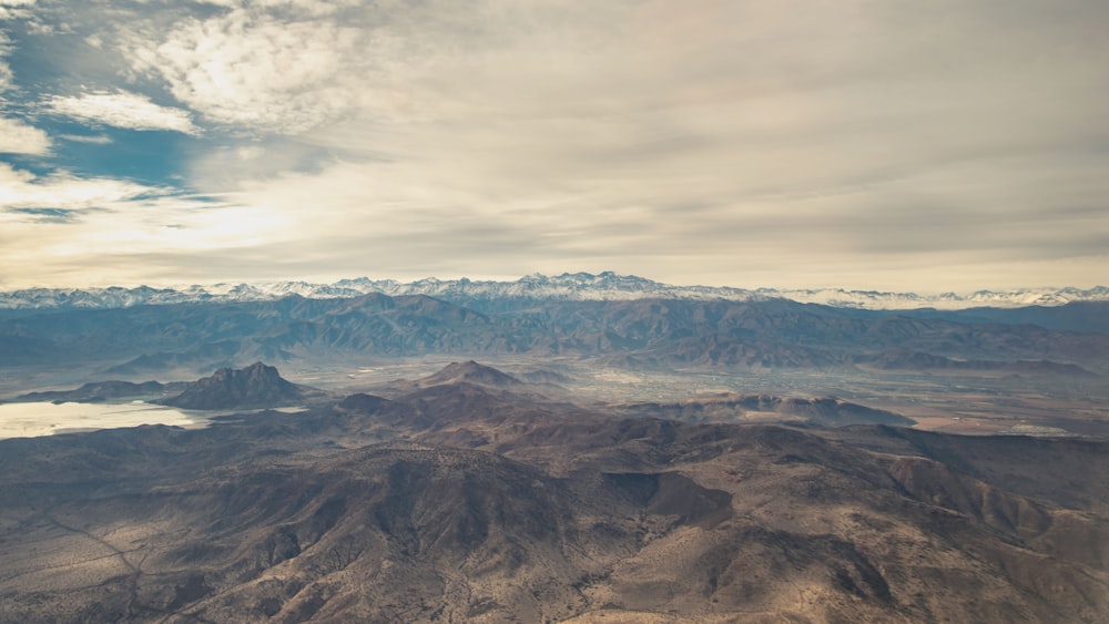 aerial photography of mountain range under cloudy sky during daytime