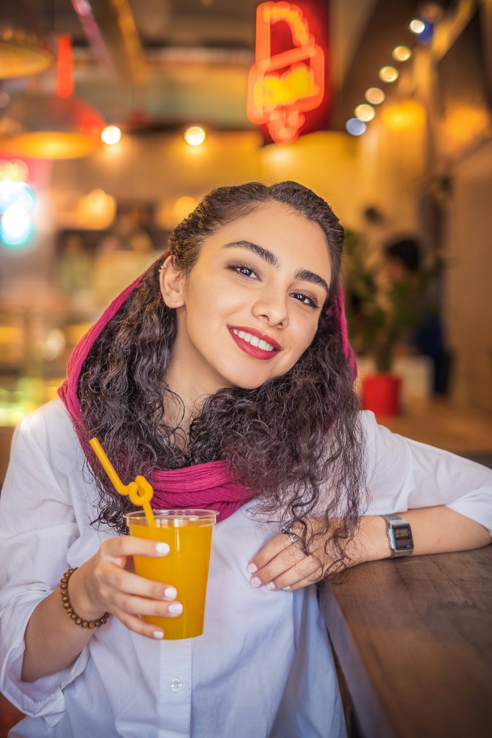 woman holding clear cup