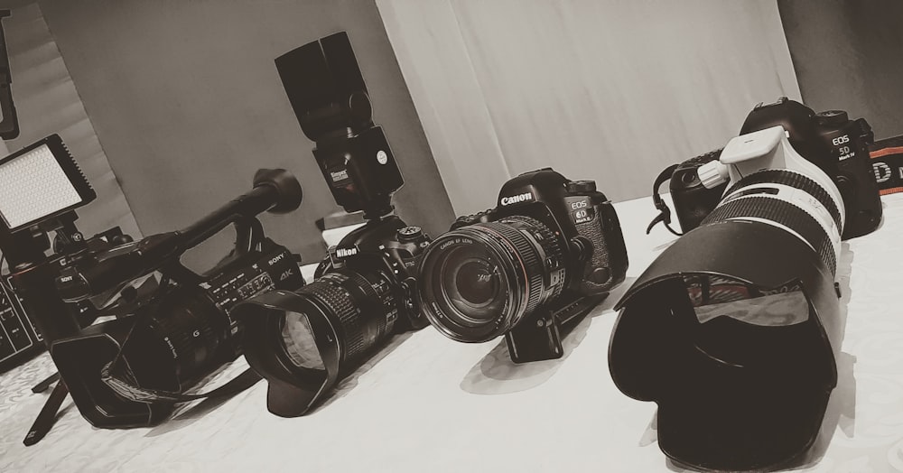three black DSLR camera