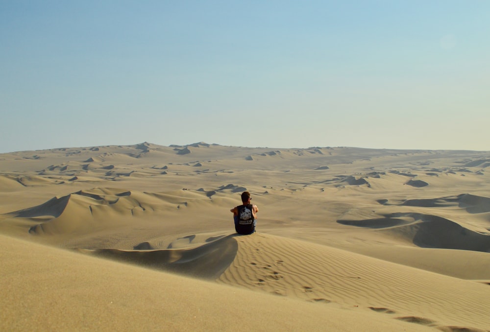 man sitting on dessert