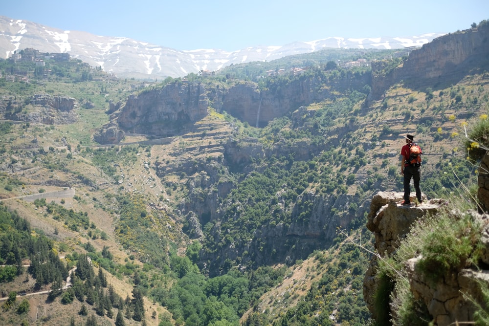 man standing on mountain cliff