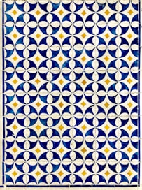 a blue and white tile with circles on it