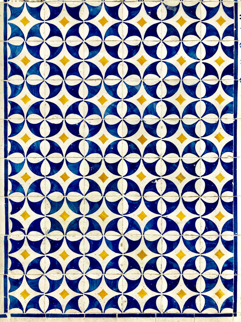 a blue and white tile with circles on it