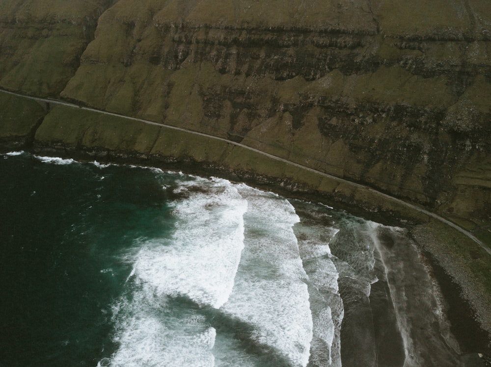 body of water beside mountain