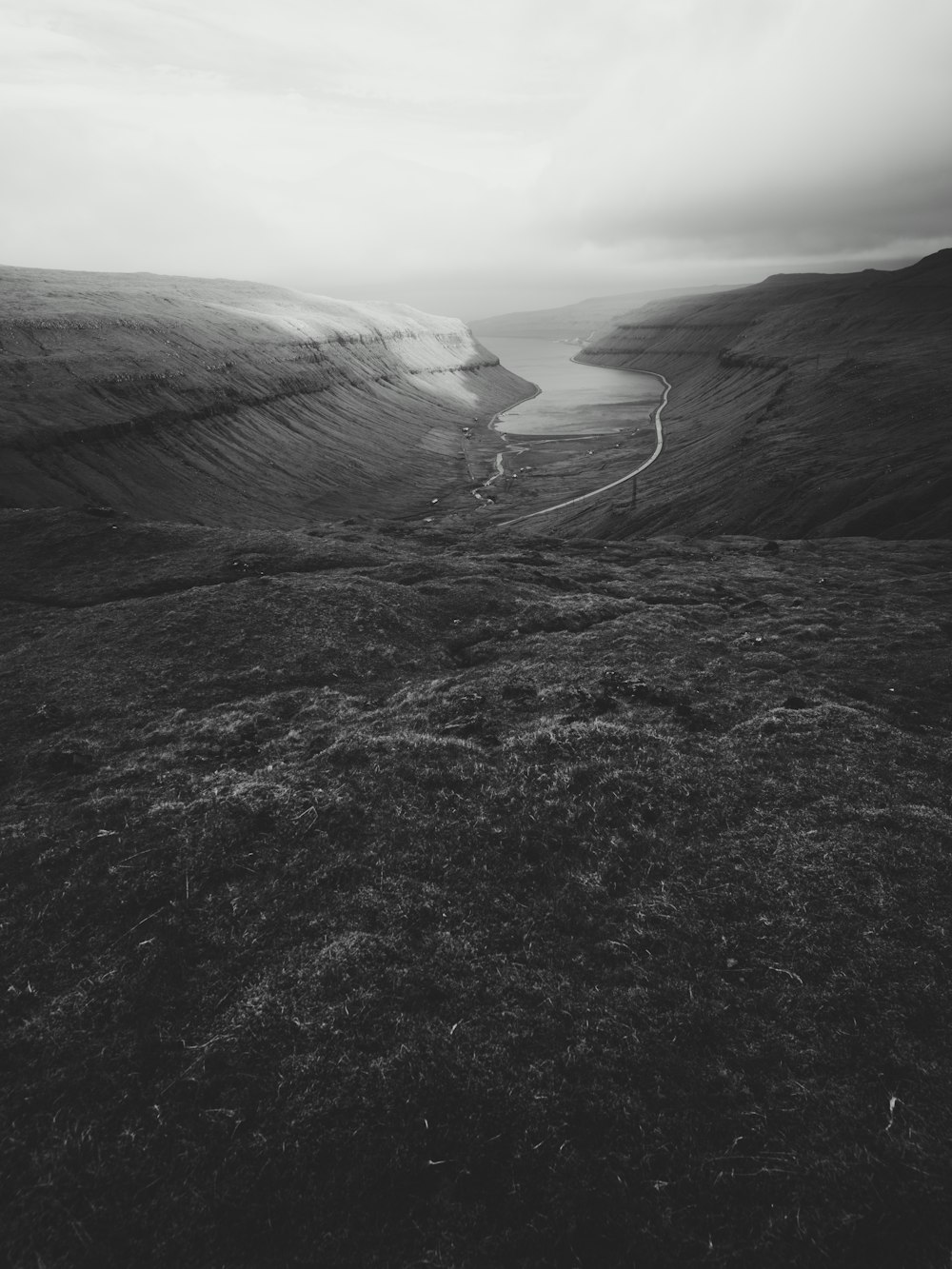 highway between hills grayscale photo