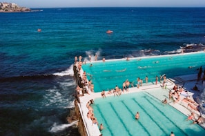 A panoramic view of the wave pool filled with smiling people enjoying the sunny day.