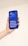 A hand holding a smartphone with a blue screen displaying the motivational text: 'Believe, Achieve, Succeed, Repeat.'