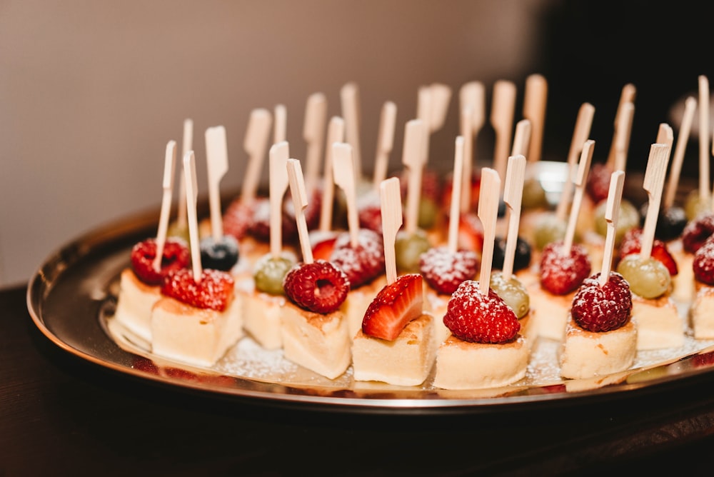 slice mini cakes with strawberry, raspberry, and blueberry on top