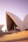 people sitting on bench on Sydney Opera House during daytime
