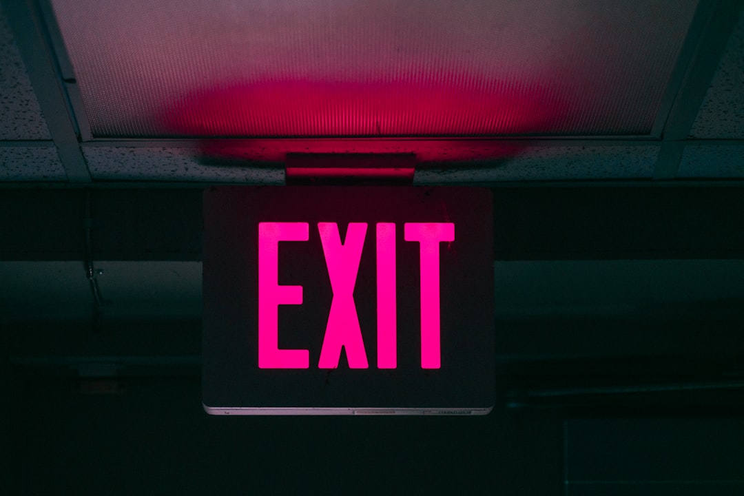 black and pink Exit signage