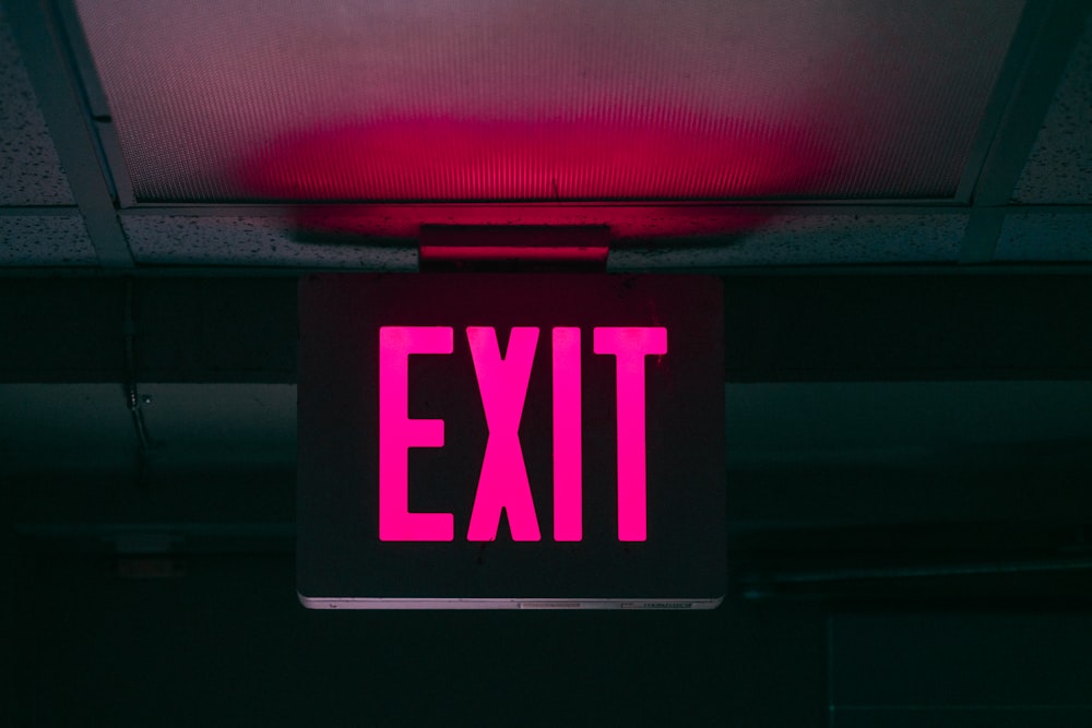 black and pink Exit signage