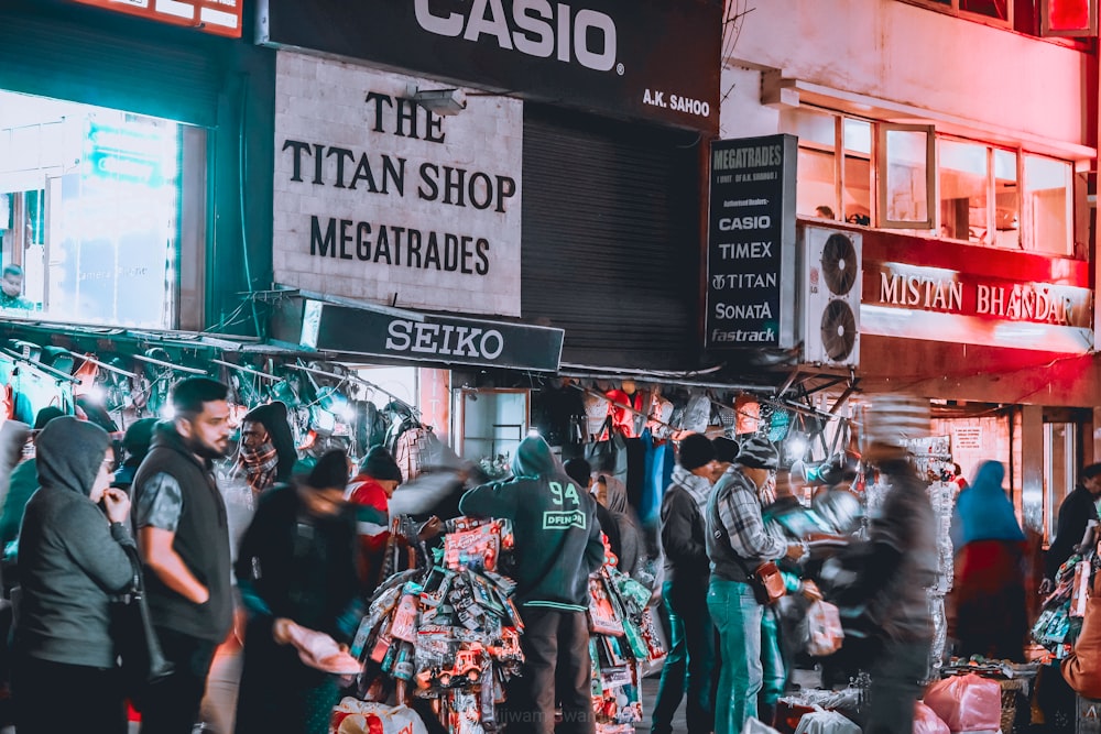 people standing on busy street during night time