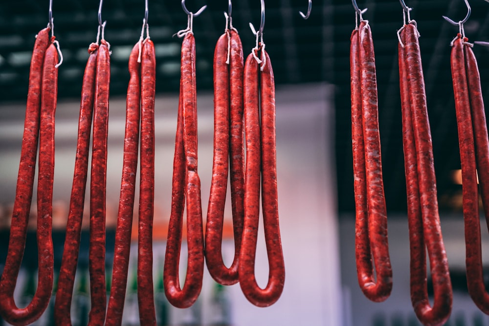 long red meat hanging from hooks
