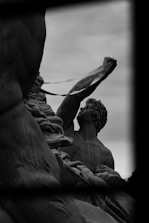 An elegant black and white image of a classical Greek statue symbolizing strength and identity.