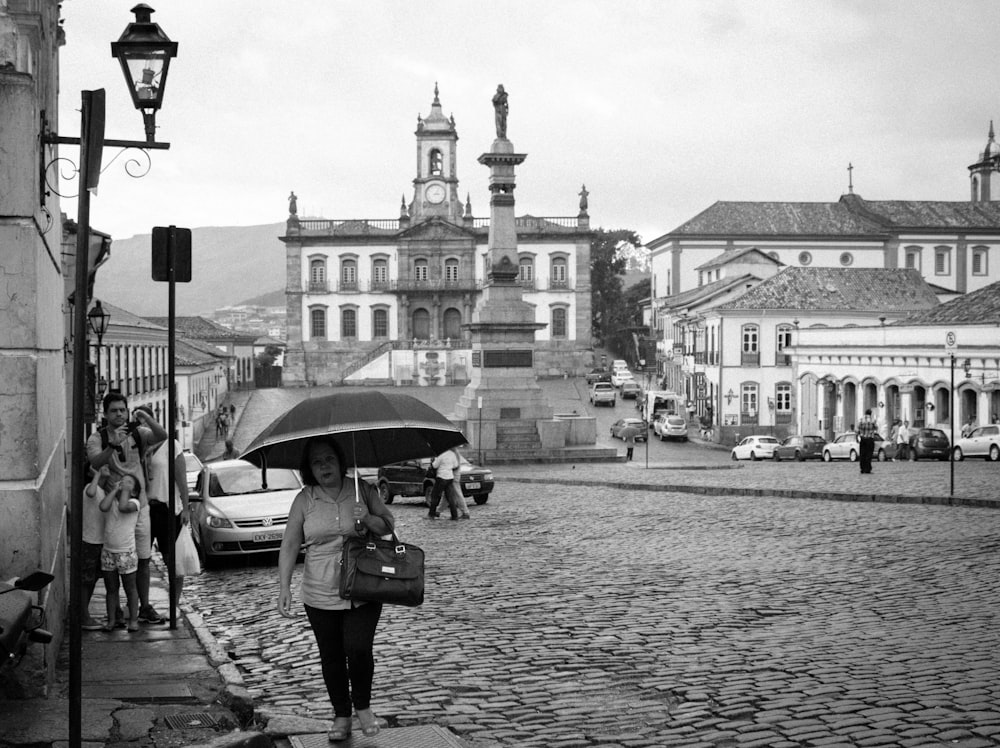 woman holding umbrella at the street
