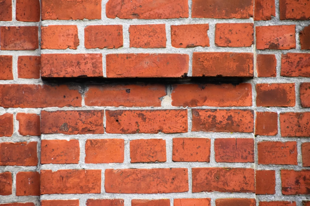 close-up photography of red bricks wall