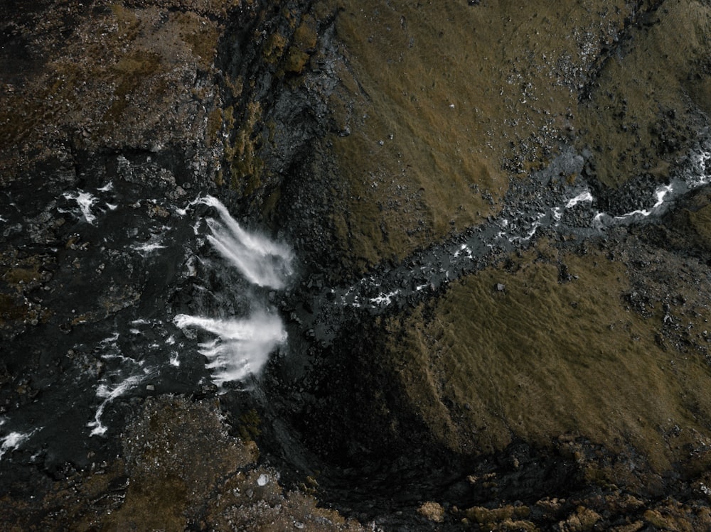 an aerial view of a stream in a rocky area