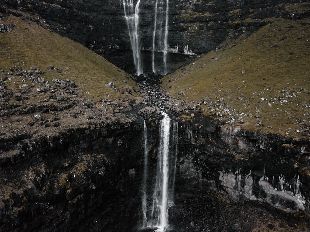 waterfalls reflection on body of water