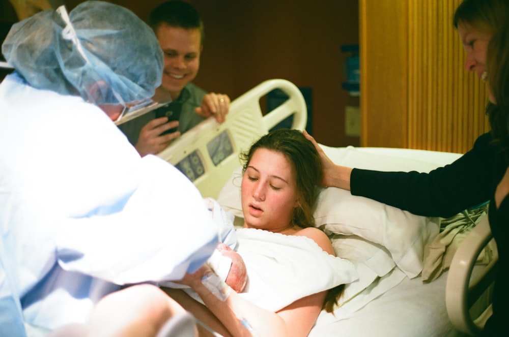 woman lying on hospital bed