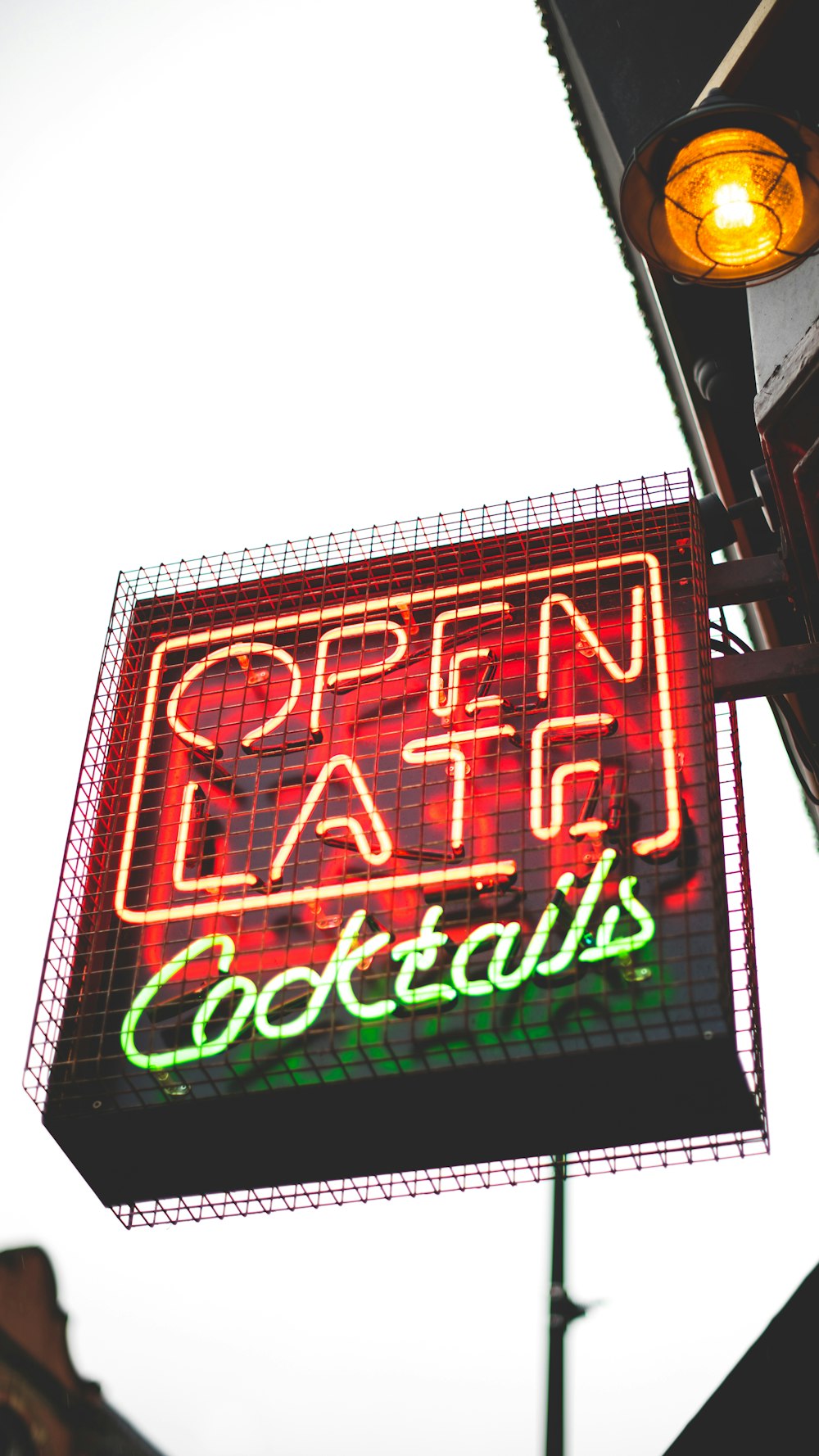 red and green Open Late Cocktails neon sign