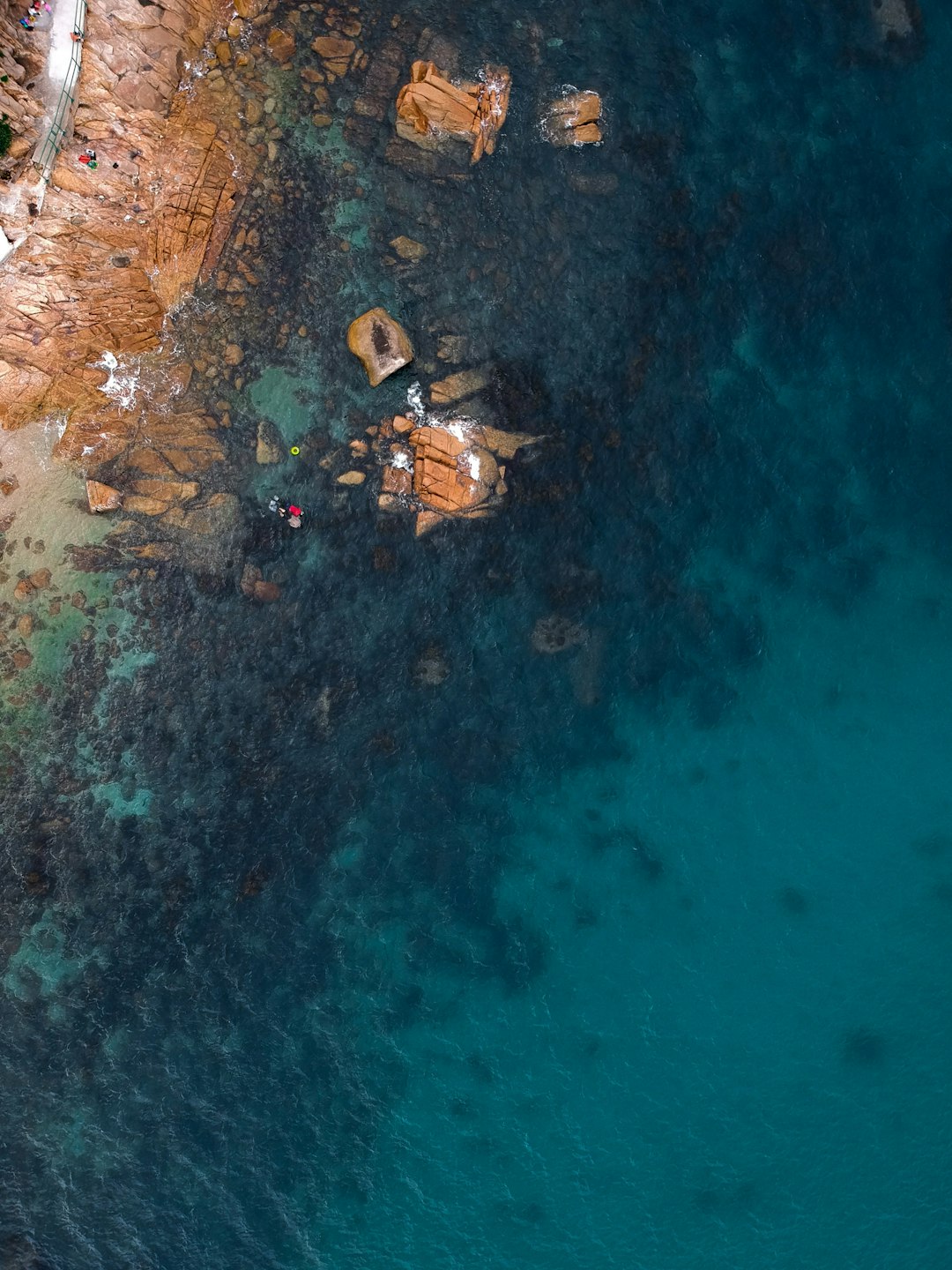 aerial photography of body of water and brown stones