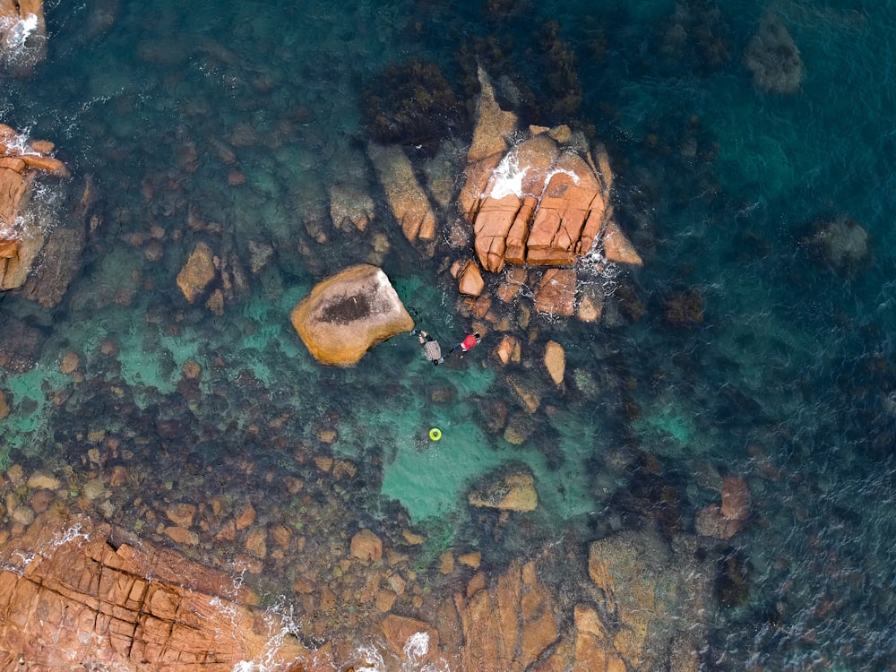 aerial photography of rock formations on body of water during daytime