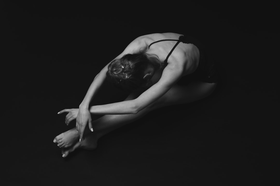 grayscale photography of unknown person stretching