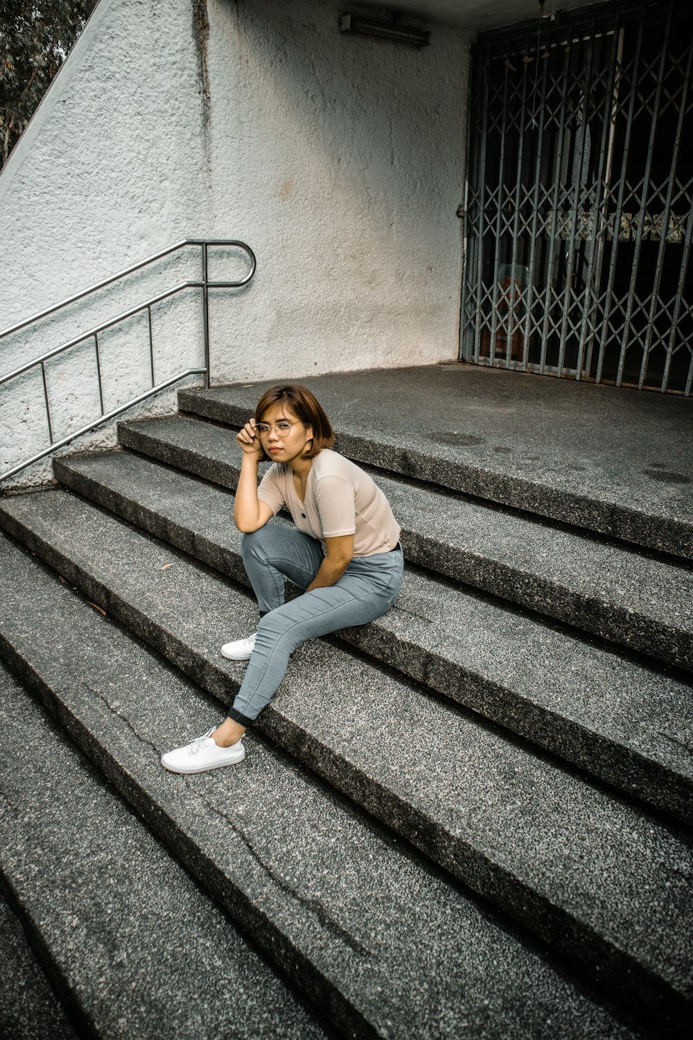 woman sitting on concrete stair