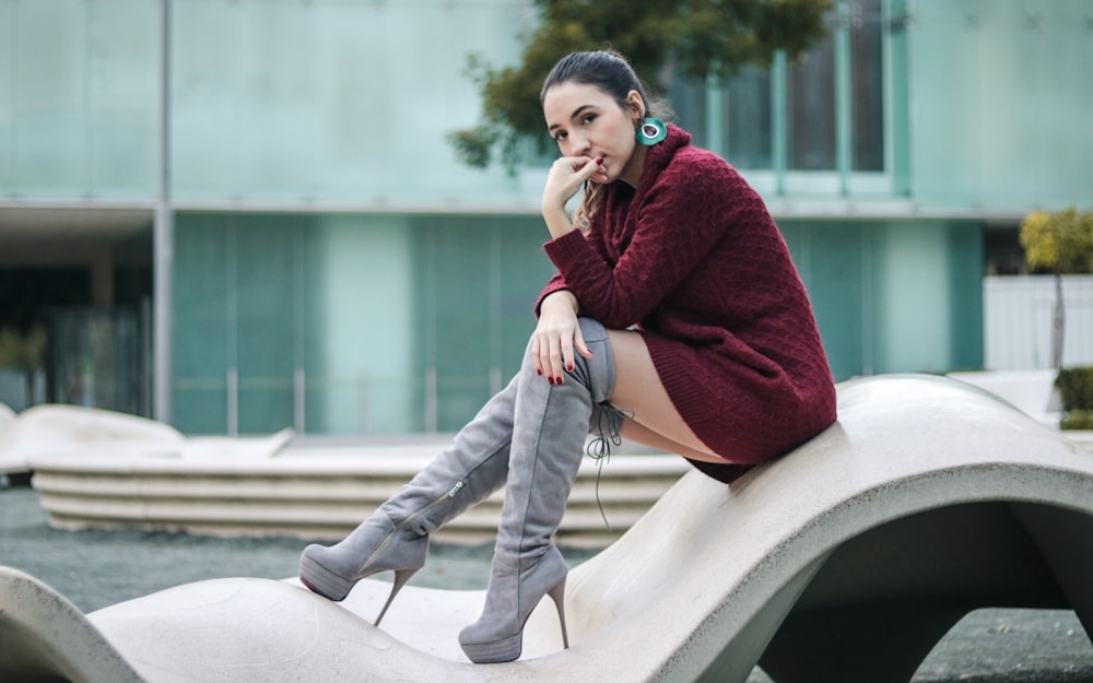 woman sitting on concrete frame
