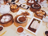 Plate of assorted dimsum varieties including chicken, cheese, mushroom, tuna, and salmon with signature sambal.